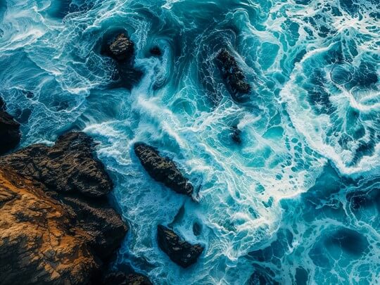 wave hitting rocky shoeline